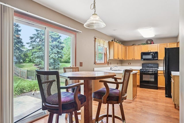 561 Ryegrass Trl, Aurora, IL 60504 - kitchen featuring black appliances, light brown cabinets, light countertops, and plenty of natural light