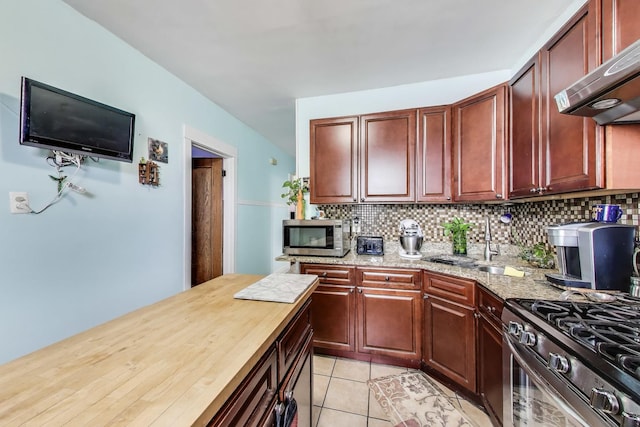 4444 N Spaulding Ave, Chicago, IL 60625 - kitchen featuring appliances with stainless steel finishes, ventilation hood, backsplash, and light tile patterned flooring