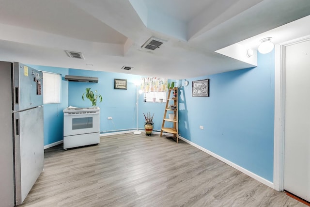 4444 N Spaulding Ave, Chicago, IL 60625 - kitchen featuring freestanding refrigerator, white electric stove, wood finished floors, and range hood