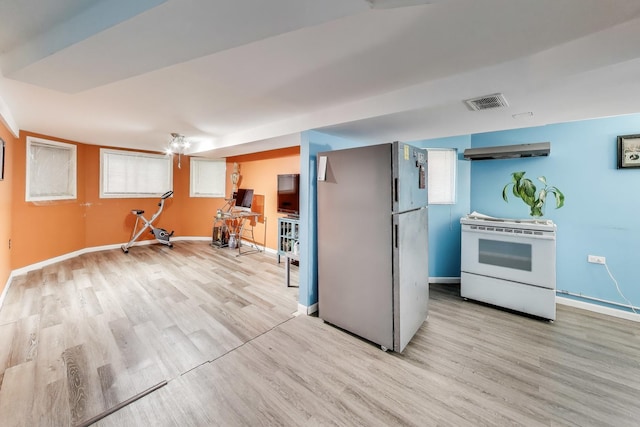 4444 N Spaulding Ave, Chicago, IL 60625 - kitchen featuring white range with electric stovetop, freestanding refrigerator, light wood-style floors, and under cabinet range hood