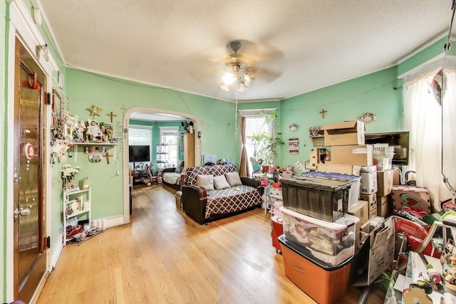 4444 N Spaulding Ave, Chicago, IL 60625 - living room with a ceiling fan, arched walkways, wood finished floors, and a textured ceiling