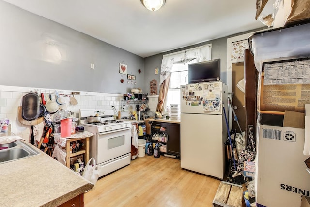 4444 N Spaulding Ave, Chicago, IL 60625 - kitchen featuring white appliances, light wood-style flooring, decorative backsplash, and light countertops