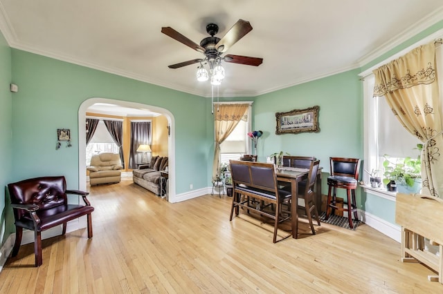 4444 N Spaulding Ave, Chicago, IL 60625 - dining area featuring arched walkways, hardwood / wood-style floors, ceiling fan, and crown molding