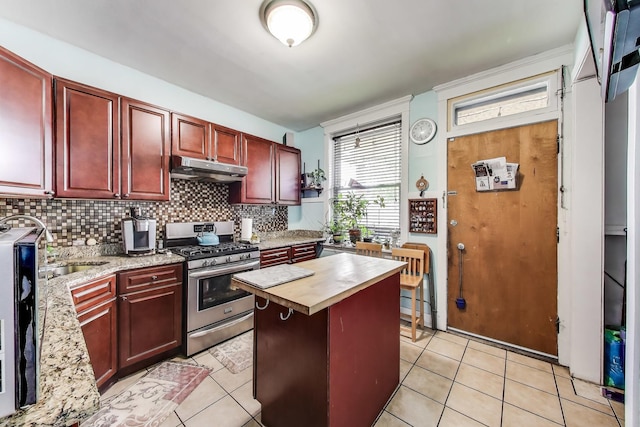 4444 N Spaulding Ave, Chicago, IL 60625 - kitchen featuring stainless steel gas stove, under cabinet range hood, dark brown cabinets, and wooden counters