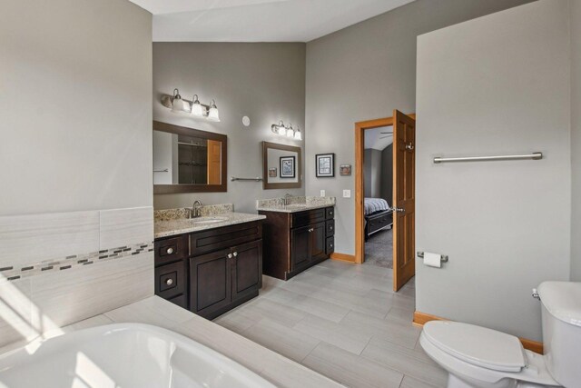 325 2nd St, Downers Grove, IL 60515 - ensuite bathroom with vanity, a bathtub, and high vaulted ceiling