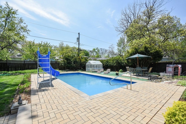325 2nd St, Downers Grove, IL 60515 - view of swimming pool featuring a fenced backyard, an exterior structure, an outdoor structure, a patio area, and a water slide