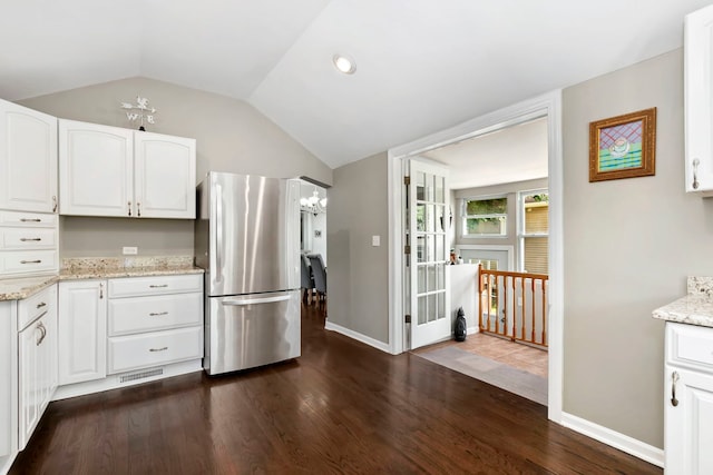 325 2nd St, Downers Grove, IL 60515 - kitchen with freestanding refrigerator, lofted ceiling, white cabinets, light stone countertops, and dark wood-style floors