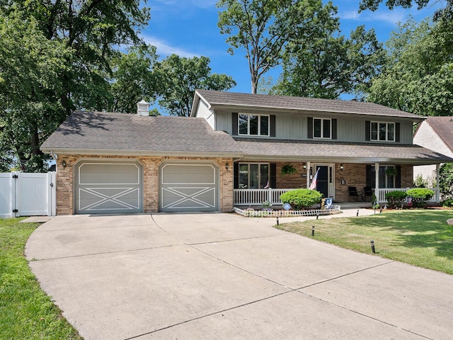 18118 Whitman Ln, Lansing, IL 60438 - view of front facade with an attached garage, driveway, brick siding, a gate, and a porch