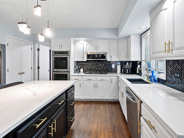 18118 Whitman Ln, Lansing, IL 60438 - kitchen featuring stainless steel appliances, dark cabinetry, white cabinetry, dark wood-style flooring, and hanging light fixtures