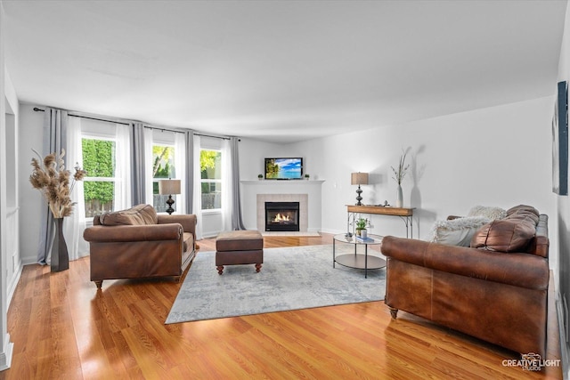 2164 Clementi Ln, Aurora, IL 60503 - living area featuring a tiled fireplace and wood finished floors