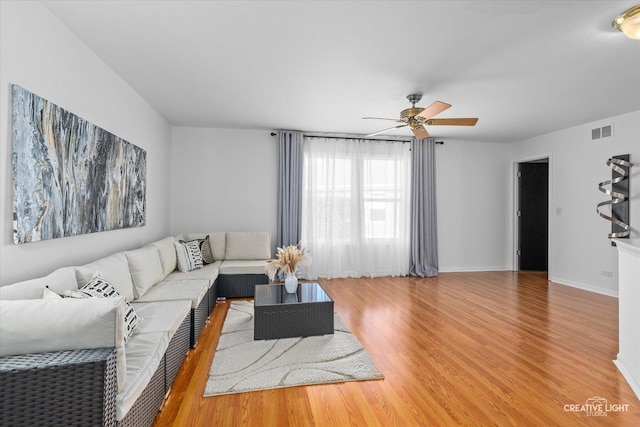 2164 Clementi Ln, Aurora, IL 60503 - living room featuring a ceiling fan and light wood-style flooring