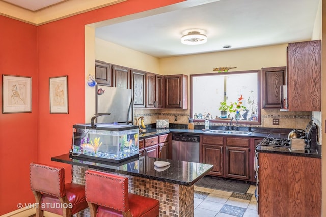 1823 N Newland Ave, Chicago, IL 60707 - kitchen with stainless steel appliances, backsplash, a breakfast bar, and dark stone countertops