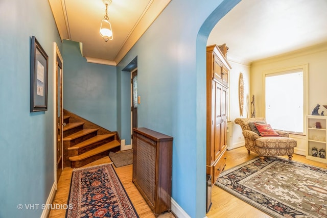 1823 N Newland Ave, Chicago, IL 60707 - corridor featuring arched walkways, light wood-style floors, crown molding, and stairway