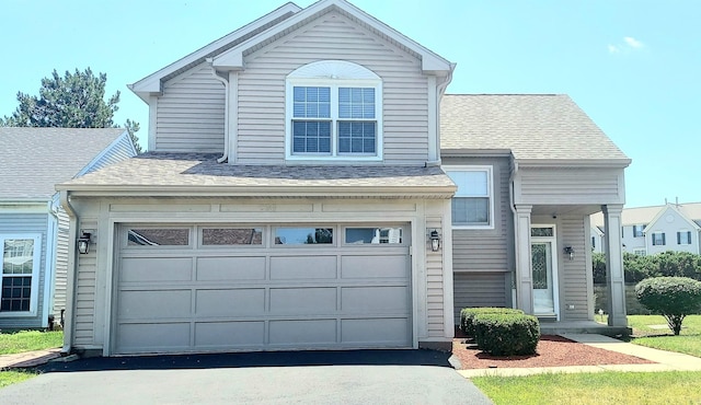100 Hamlet Cir, Montgomery, IL 60538 - view of front facade featuring asphalt driveway, a shingled roof, and a garage