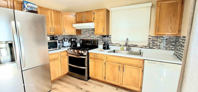 100 Hamlet Cir, Montgomery, IL 60538 - kitchen featuring stainless steel appliances, under cabinet range hood, tasteful backsplash, and light countertops