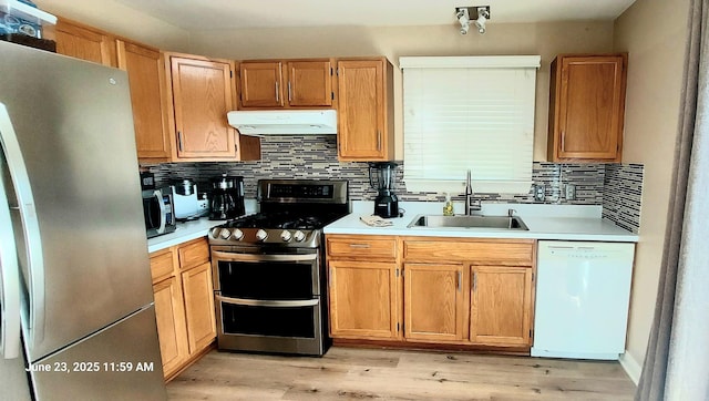 100 Hamlet Cir, Montgomery, IL 60538 - kitchen featuring stainless steel appliances, extractor fan, decorative backsplash, and light countertops