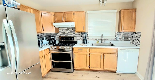 100 Hamlet Cir, Montgomery, IL 60538 - kitchen with stainless steel appliances, under cabinet range hood, light brown cabinets, and decorative backsplash