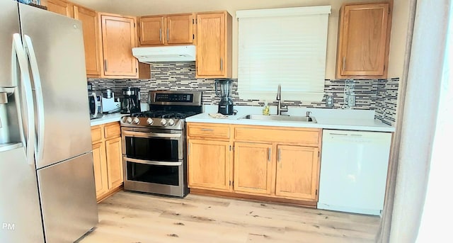 100 Hamlet Cir, Montgomery, IL 60538 - kitchen featuring stainless steel appliances, under cabinet range hood, light brown cabinetry, light wood-style floors, and tasteful backsplash