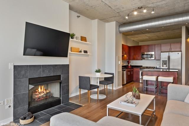 700 N Larrabee St Unit 1111, Chicago, IL 60654 - living area with dark wood-style flooring and a tiled fireplace