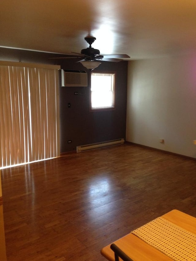 4305 W Shamrock Ln Unit 2F, Mchenry, IL 60050 - unfurnished room with baseboard heating, ceiling fan, a wall mounted air conditioner, and wood finished floors