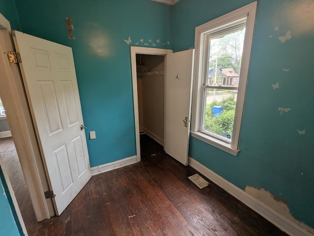 7017 S Hermitage Ave, Chicago, IL 60636 - unfurnished bedroom featuring wood finished floors, multiple windows, and a closet