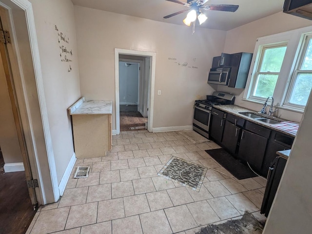 7017 S Hermitage Ave, Chicago, IL 60636 - kitchen with appliances with stainless steel finishes, a ceiling fan, light countertops, and light tile patterned floors