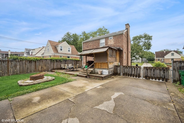 1316 Heidorn Ave, Westchester, IL 60145 - rear view of house featuring brick siding, a chimney, and a patio area