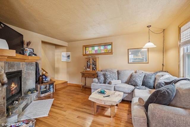 1316 Heidorn Ave, Westchester, IL 60145 - living area featuring light wood-type flooring, a textured ceiling, and a fireplace