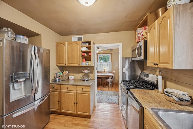 1316 Heidorn Ave, Westchester, IL 60145 - kitchen with appliances with stainless steel finishes, open shelves, light wood finished floors, light countertops, and light brown cabinetry