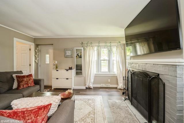 7718 Beach Rd, Wonder Lake, IL 60097 - living room with wood finished floors, a fireplace, and ornamental molding