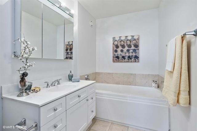 330 W Grand Ave Unit 2106, Chicago, IL 60654 - full bath featuring vanity, a bath, and tile patterned flooring