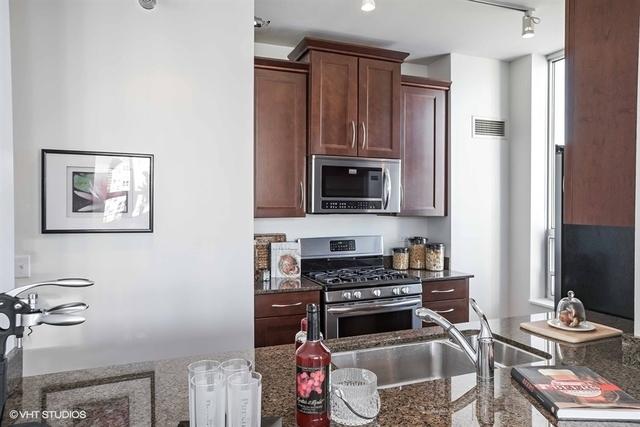 330 W Grand Ave Unit 2106, Chicago, IL 60654 - kitchen with appliances with stainless steel finishes and dark stone countertops