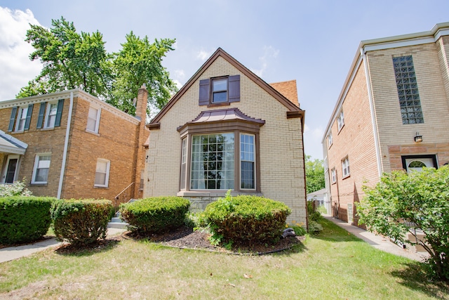 6444 N Oketo Ave, Chicago, IL 60631 - view of front facade featuring brick siding and a front lawn