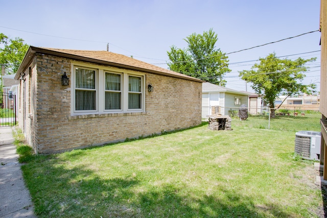6444 N Oketo Ave, Chicago, IL 60631 - view of home's exterior with brick siding, a fenced backyard, and a shingled roof