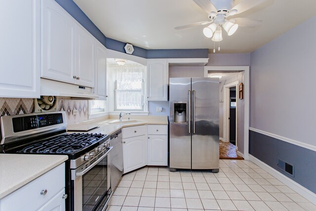 6444 N Oketo Ave, Chicago, IL 60631 - kitchen featuring stainless steel appliances, under cabinet range hood, white cabinets, and light countertops