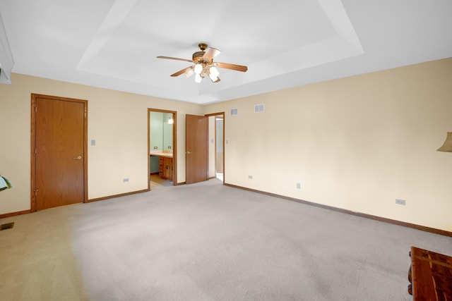 1860 Harvard Ln, New Lenox, IL 60451 - unfurnished bedroom with a tray ceiling, light carpet, ensuite bathroom, and ceiling fan