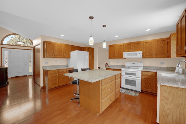 1860 Harvard Ln, New Lenox, IL 60451 - kitchen with white appliances, a kitchen island, a kitchen bar, light wood-style flooring, and recessed lighting