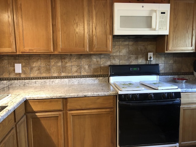 6430 S Lorel Ave, Chicago, IL 60638 - kitchen with electric stove, white microwave, backsplash, and light stone countertops