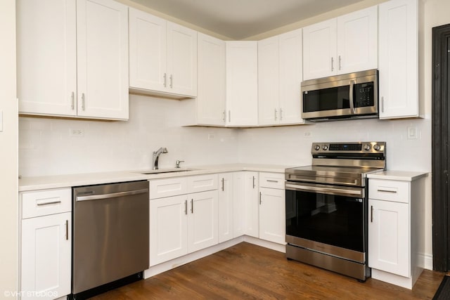 1006 E 54th St Unit J-2, Chicago, IL 60615 - kitchen with stainless steel appliances, light countertops, decorative backsplash, and white cabinets