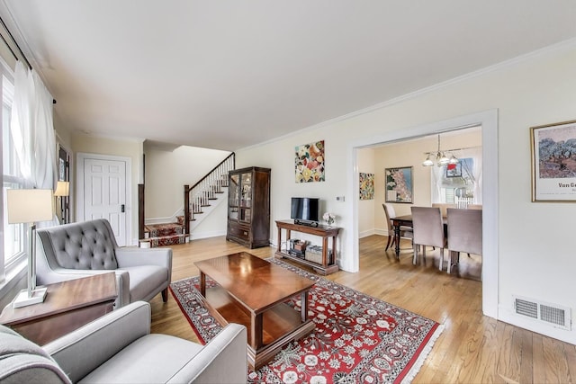 1314 Saint Johns Ave, Highland Park, IL 60035 - living area with stairs, light wood-style floors, ornamental molding, and a chandelier