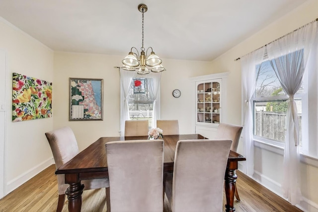 1314 Saint Johns Ave, Highland Park, IL 60035 - dining area with a chandelier and wood finished floors