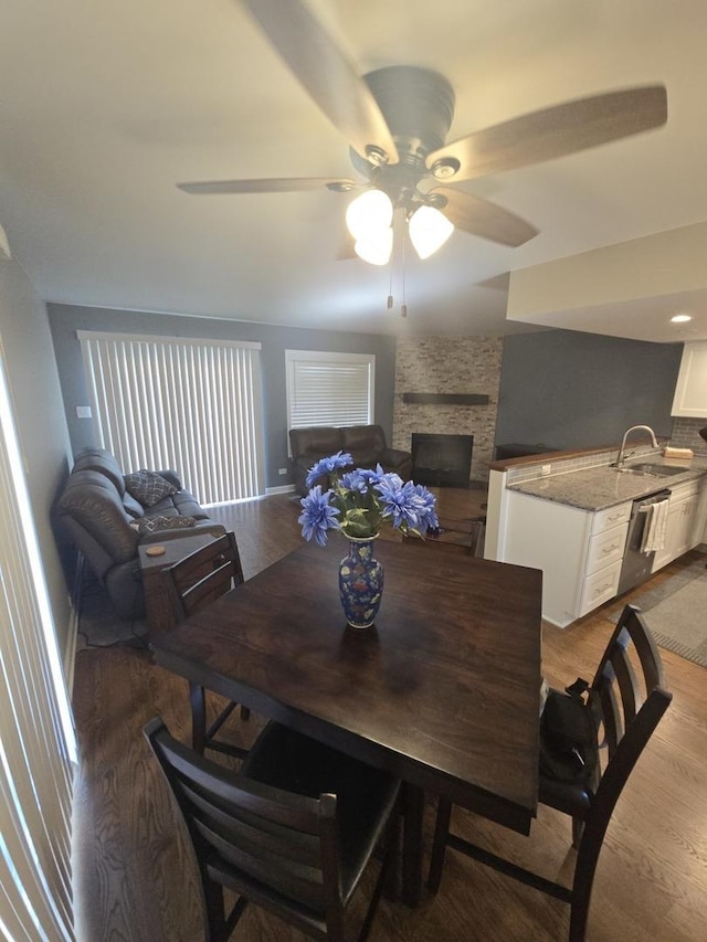 8201 Daniel Dr, Justice, IL 60458 - dining space featuring wood finished floors, a ceiling fan, and a fireplace