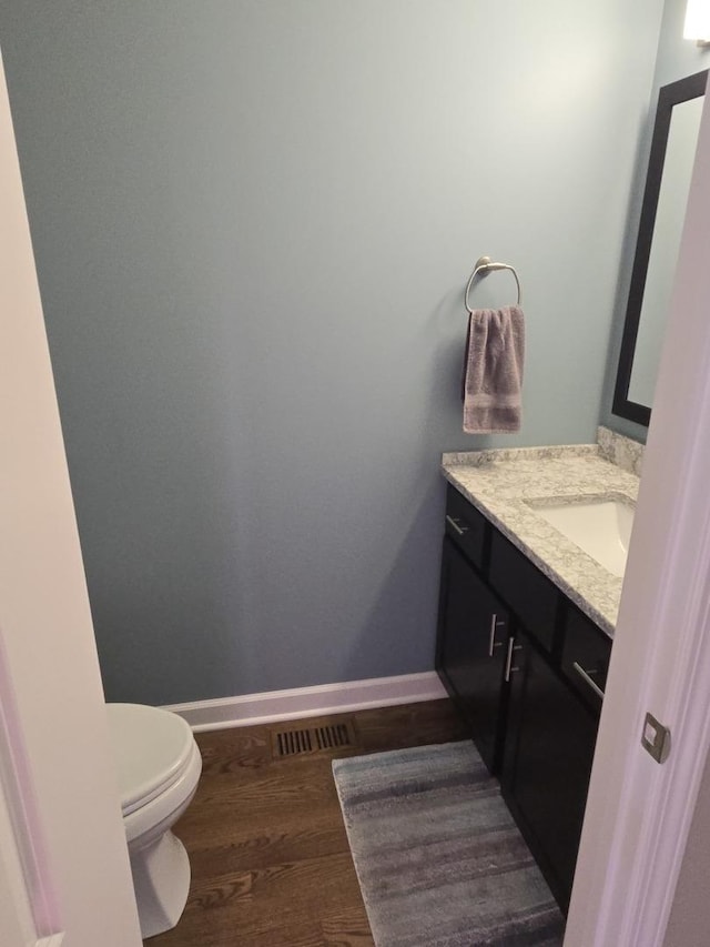 8201 Daniel Dr, Justice, IL 60458 - half bathroom featuring vanity and wood finished floors