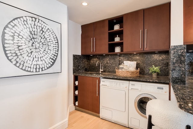 950 N Michigan Ave Unit 4502, Chicago, IL 60611 - kitchen with washer and dryer, open shelves, light wood-type flooring, decorative backsplash, and dark stone countertops