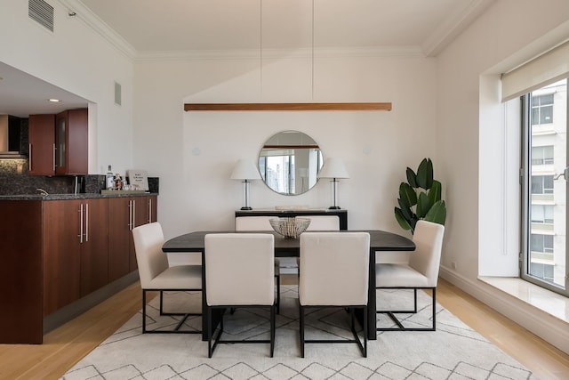 950 N Michigan Ave Unit 4502, Chicago, IL 60611 - dining space featuring light wood-style flooring, healthy amount of natural light, and ornamental molding