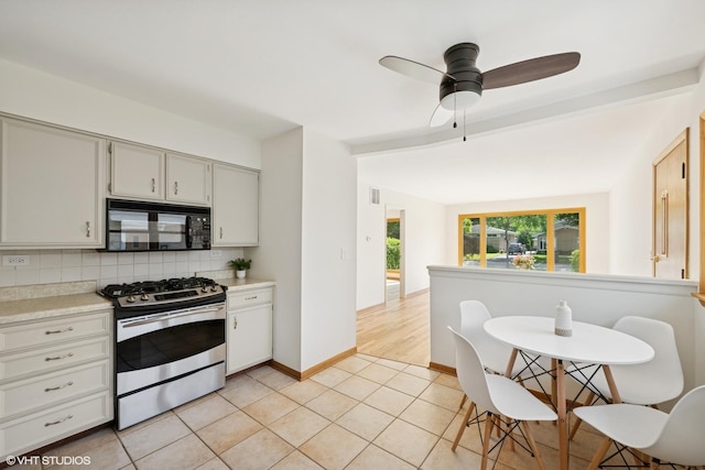 1114 S Mitchell Ave, Arlington Heights, IL 60005 - kitchen featuring black microwave, stainless steel range with gas cooktop, tasteful backsplash, light countertops, and ceiling fan