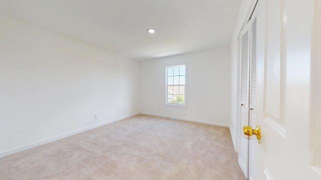 3901 Tallgrass Dr, Champaign, IL 61822 - unfurnished bedroom with a closet, light carpet, and recessed lighting