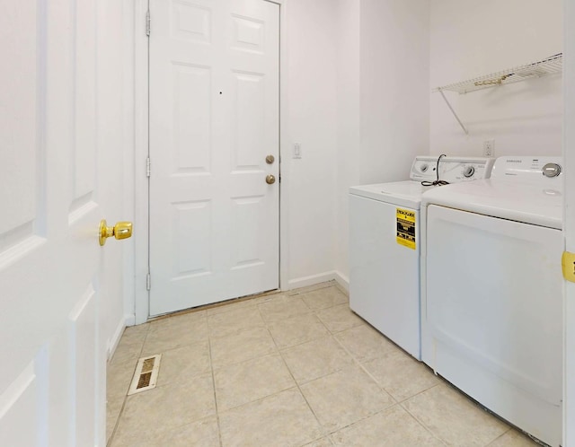 3901 Tallgrass Dr, Champaign, IL 61822 - laundry room with washing machine and clothes dryer and light tile patterned floors
