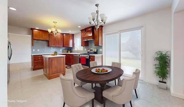 3901 Tallgrass Dr, Champaign, IL 61822 - kitchen with appliances with stainless steel finishes, a chandelier, a kitchen island, tasteful backsplash, and recessed lighting
