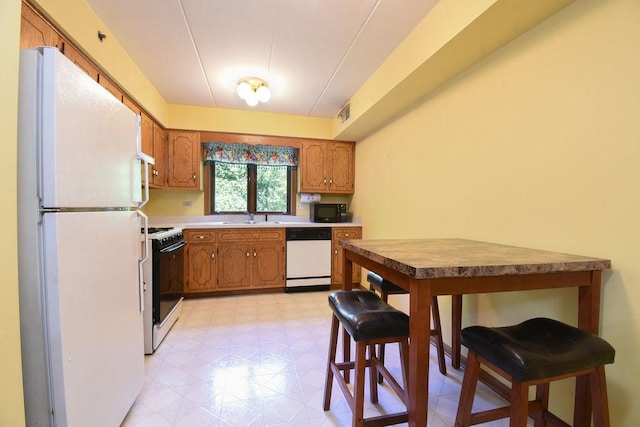 10278 SW Hwy Unit 1D, Chicago Ridge, IL 60415 - kitchen with white appliances, light floors, and brown cabinetry
